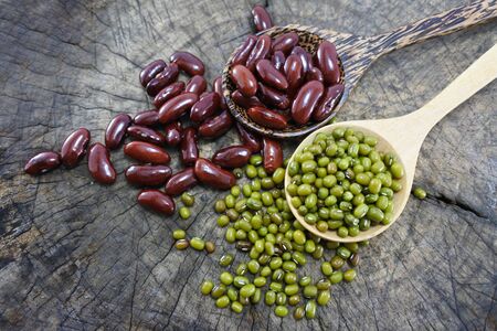 Green beans and Red bean in the wooden spoon on wood backgroundの写真素材