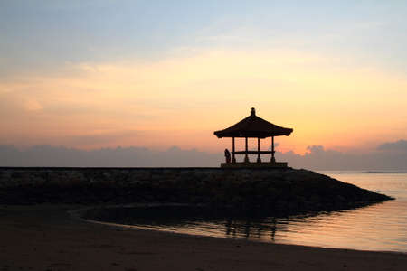hut sillhoutte at beach in the morningの写真素材
