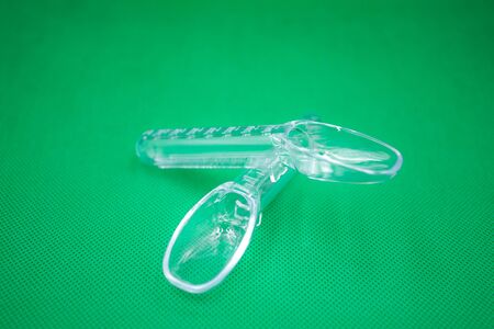 Spoon for feeding children on the green ground.の写真素材