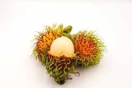 Three rambutans placed on a white ground.の写真素材