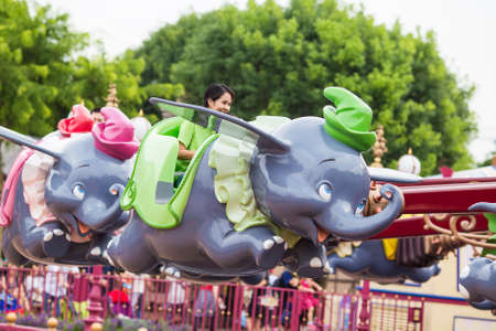 Lantau Island,Hong Kong,Hong Kong Disneyland,Sep 21 2015.Tourists are enjoying this ride called Dumbo the flying Elephant.のeditorial素材