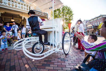Lantau Island,Hong Kong,November 25 2015.This man is playing the piano and riding bicycle,which is a show for children in Disneyland Hong Kong.のeditorial素材