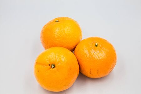 Three oranges were placed on a white ground.の写真素材