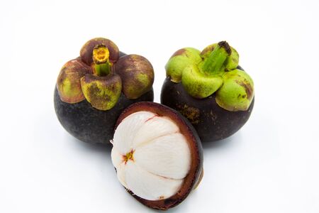 Three mangosteen placed on a white ground.の写真素材