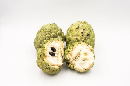 Four custard apples placed on a white ground.の写真素材