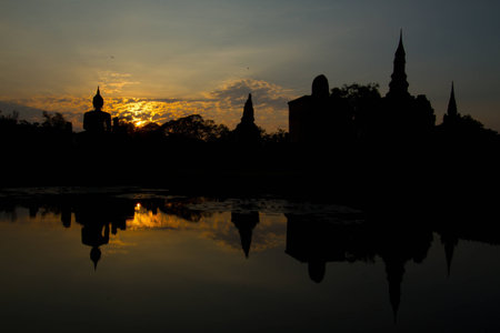 Big Buddha in the sunlight in the evening at Wat Mahathat temple in old Sukhothai capital city in Sukhothai historical park in Northern of Thailand  の写真素材