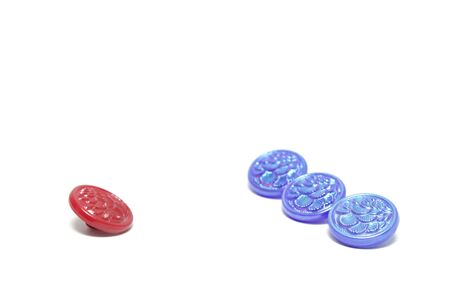 One red button and three blue ones isolated on white backgroundの写真素材