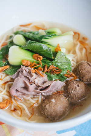 Vietnamese noodle soup with pork and vegetables in a bowl