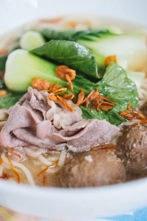Vietnamese noodle soup with pork and vegetables in a bowl