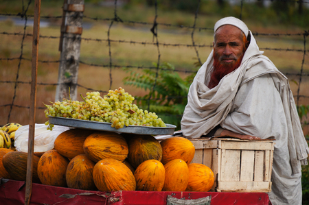 Unidentified Pakistani man sells fresh fruits at market on October 20, 2014 in  Pakistan.のeditorial素材