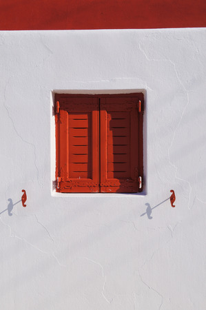 Red window with white wall on Mykonos Island, Greece, Europeの写真素材
