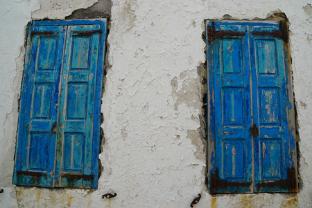 Old windows on white wall in Mykonos,Greece.の写真素材