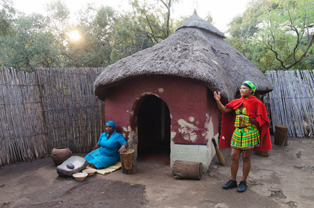 Lesedi Cultural Village, South Africa - 20 October 2016: African woman cooking maize meal at tribal house at Lesedi Village, South Africa.Maize meal is basic African ingredient.のeditorial素材