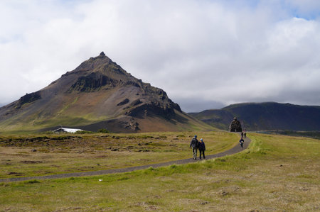 Snaefellsness peninsula,Iceland- 26 June 2017: Unidentified tourists walking near Statue of Bardur Snaefellsnes, half-man, half-giant that is said to roam the Snaefellsnes glacier in Iceland.のeditorial素材