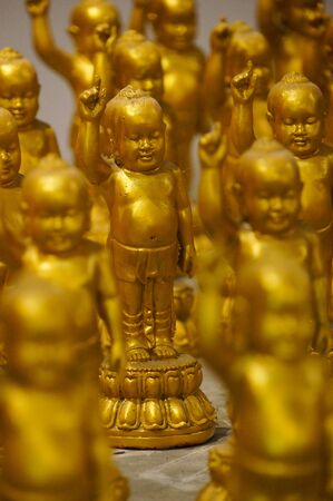 Golden statue of buddha when he was young in a temple,Northern Thailand.の写真素材