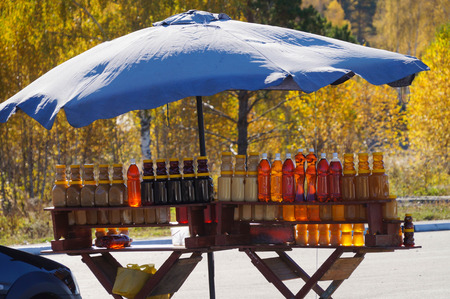 Bottles of honey for sale in autumn,Altai Repulic,Russia.の写真素材