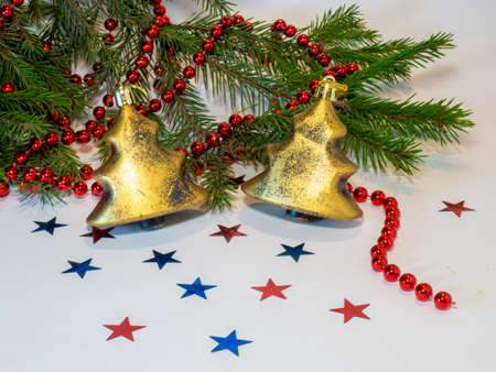 Christmas toys and fir branches with beads on a white backgroundの写真素材