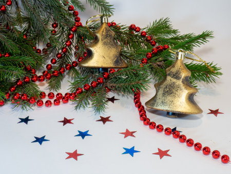Christmas toys and fir branches with beads on a white backgroundの写真素材