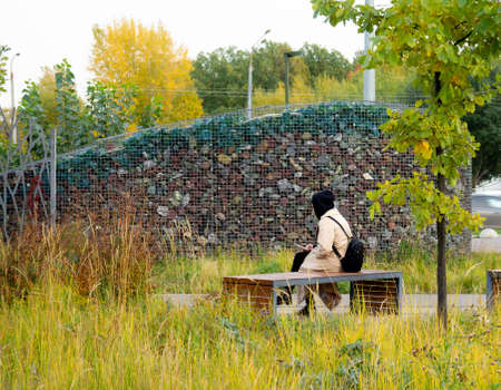 A girl sitting on a benchの写真素材