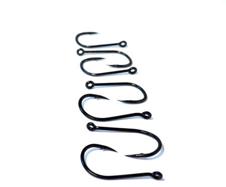 fish hooks for catching carp on a white background. A row of fish hooksの写真素材