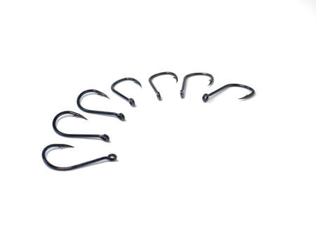 fish hooks for catching carp on a white background. A row of fish hooksの写真素材