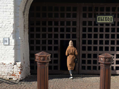 The girl goes through the gate. Antique doorsの写真素材