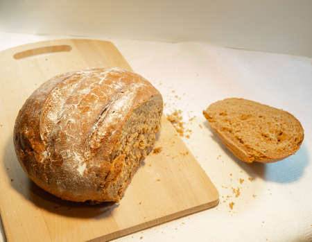 Cut rye bread lies on the board. Fresh bakeryの写真素材