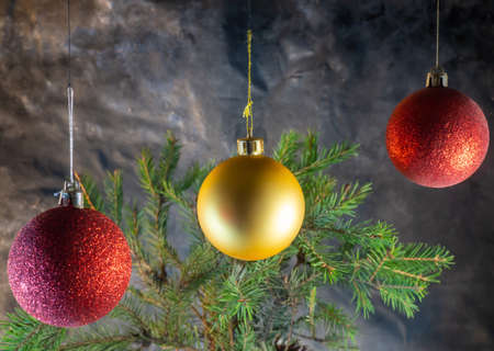 golden and red Christmas balls on the background of fir branches. Christmas decorationの写真素材