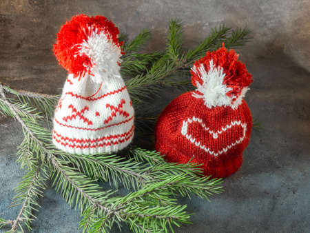 Christmas hats lit on fir branches. Christmas decoration. New Year's atmosphere.の写真素材
