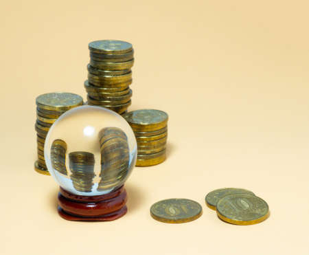Pyramids of coins are reflected in a glass ball.の写真素材
