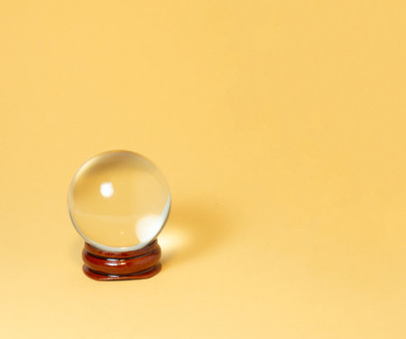 Crystal ball on a yellow background.の写真素材