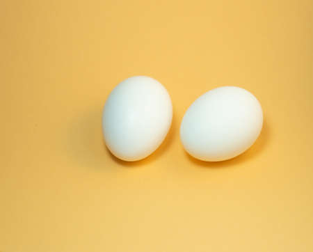 two eggs on a beige background. Two  chicken eggsの写真素材