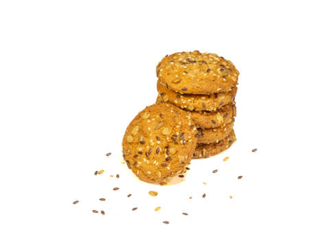 A stack of oatmeal cookies with cereals and nuts on a white plate. Healthy dietの写真素材