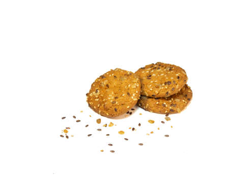 Three oatmeal cookies with cereals and nuts on a white plate. Healthy dietの写真素材