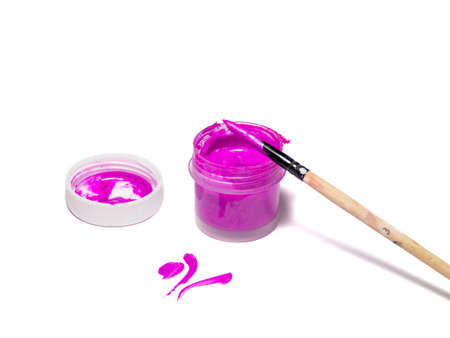 A jar of acrylic paints and a brush in paint. Purple paint on white backgroundの写真素材
