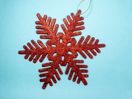 Red snowflake on a blue background. New Year card, decorationの写真素材