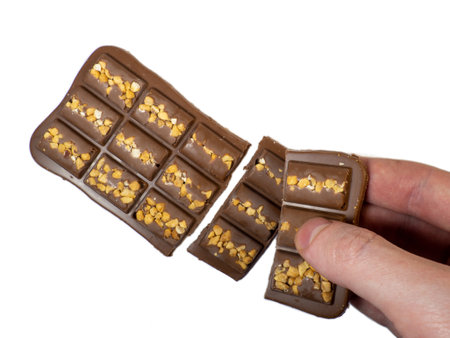 Milk chocolate bar with nuts on a white background.Chocolate dessertの写真素材