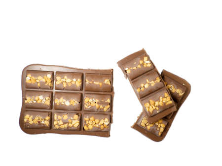 Milk chocolate bar with nuts on a white background.の写真素材