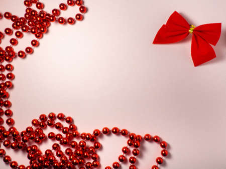New Year card. Christmas card on a pink background. Decorations for the holiday.
Red bow and red beadsの写真素材