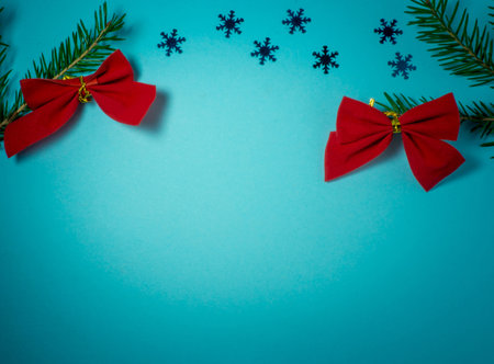 New Year card. Christmas card on a blue background. Fir branches. Decorations for the holiday.
 Cristmas trees. Christmas toys. Red bows on a branchの写真素材