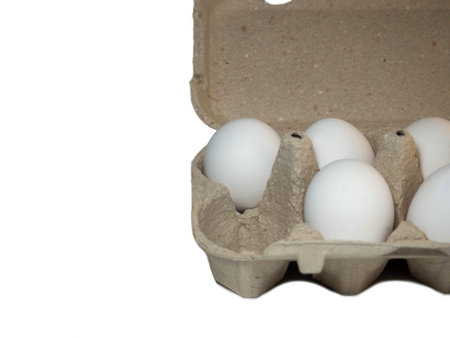 Eggs in a box. A dozen eggs. Kitchen.