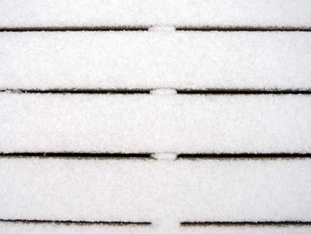 Wooden boards covered with a thin layer of first snow. First snow. Background, textureの写真素材