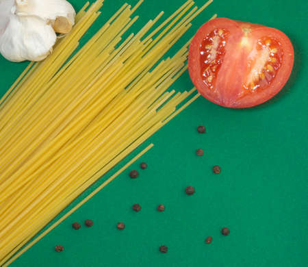 spaghetti, garlic and half a tomato. Cooking dinnerの写真素材