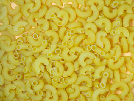 Not boiled pasta on the table. Background from pasta. Pasta hornsの写真素材