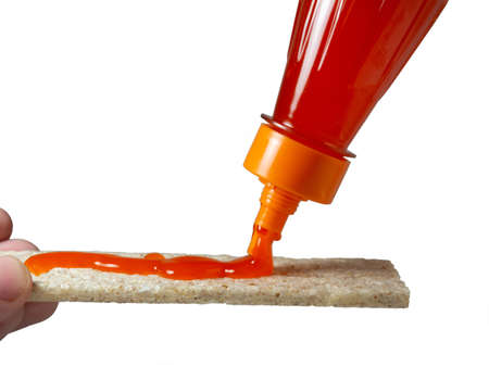 A loaf of bread is poured with a spicy sauce. Seasoning for foodの写真素材