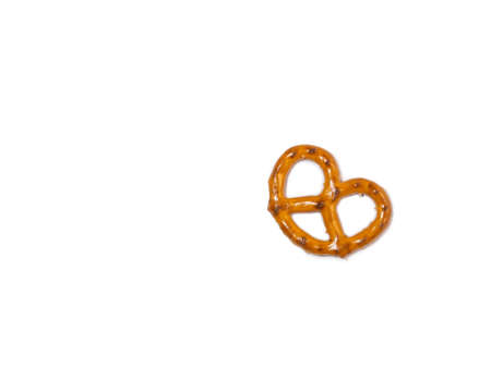 Small pretzel on a white background. Flour product. Baking for tea. Crispy biscuit.Pastries of an interesting unusual shape.の写真素材