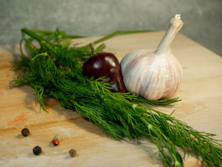Still life on a black background. Multi-colored peppercorns ,  dill and garlic. Vegeterianianの写真素材