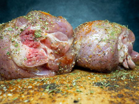 Turkey drumsticks in spices lie on a kitchen cutting board. Poultry meat. Turkey leg. Juicy meat is waiting to be cooked. Waiting for the oven. Hamの写真素材