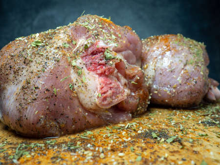 Turkey drumsticks in spices lie on a kitchen cutting board. Poultry meat. Turkey leg. Juicy meat is waiting to be cooked. Waiting for the oven. Hamの写真素材