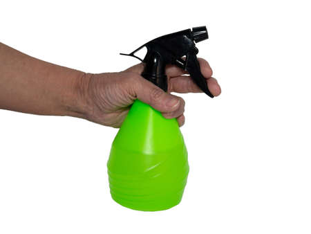 Hand holds a spray bottle. Watering flowers. Gardening, plant care. Waterの写真素材
